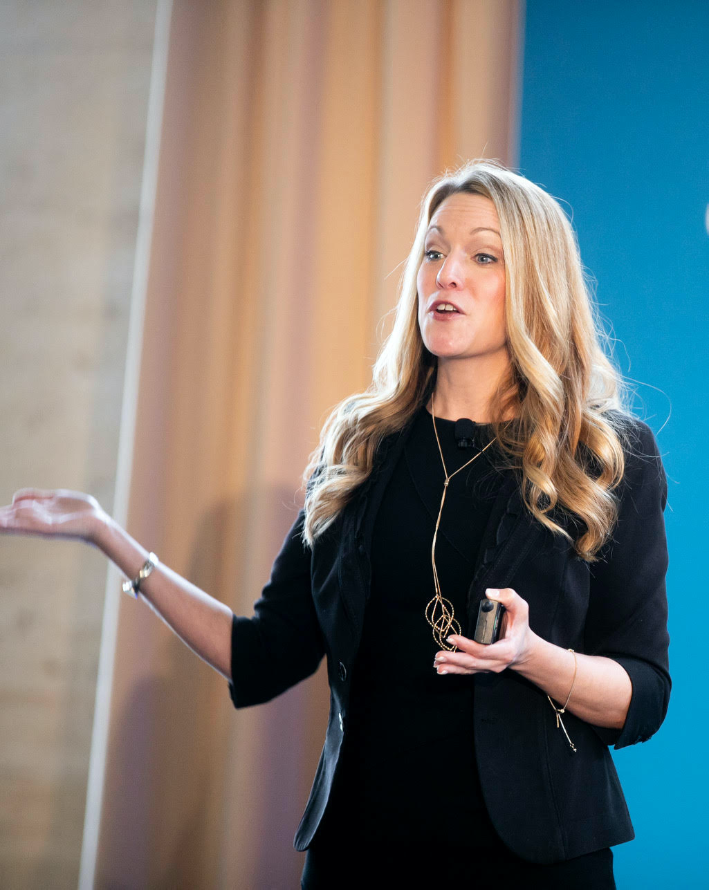 Dr. Melissa Milanak standing up giving a keynote speech for Barron's