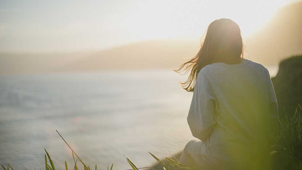 Woman looking at the ocean