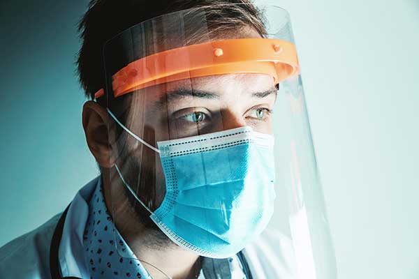 Healthcare worker in mask and faceshield